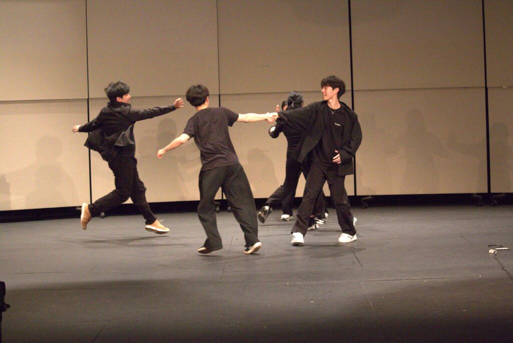 Four students dance 
